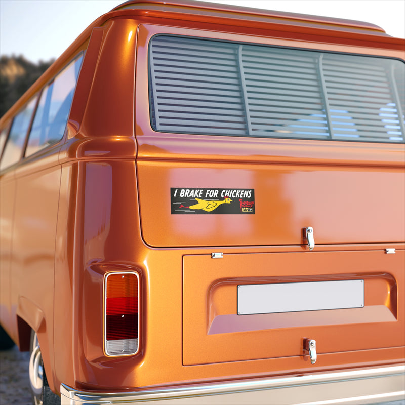 Rear view of an orange van showing the I Brake for Chickens Svengoolie bumper sticker on its back panel below the rear window.