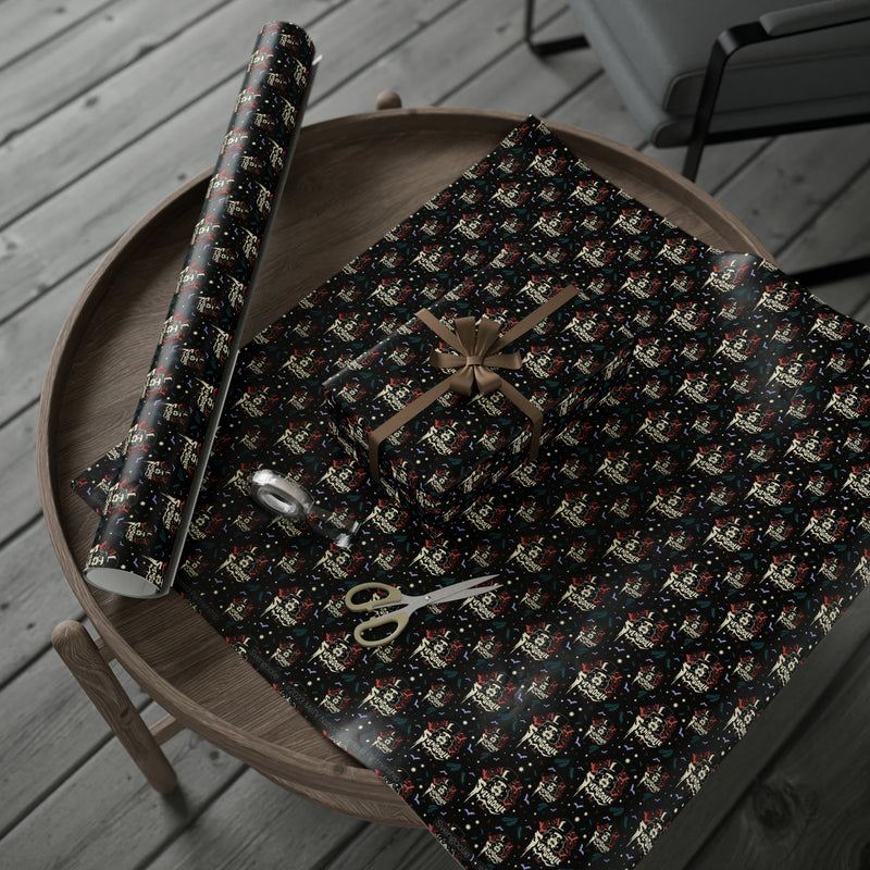 Svengoolie wrapping paper roll and a folded sheet on a round wooden table with a bow-tied gift and gold scissors.