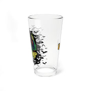 Side view of the clear IMP pint glass showing the IMP character and bats wrapping around the left side, with the yellow IMP logo on the right side.