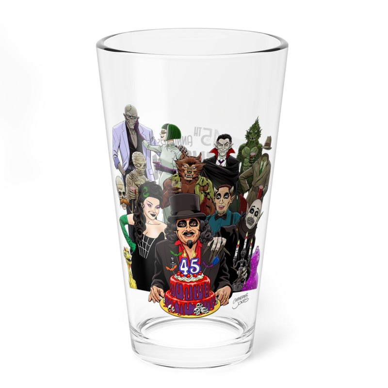 Clear pint glass featuring an illustration of Svengoolie holding a birthday cake with a candle reading 45, surrounded by classic monster characters.