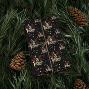 Gift box wrapped in Svengoolie wrapping paper tied with twine, resting on pine branches beside two pinecones.