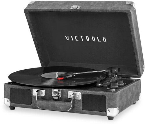 Angled view of open grey suitcase turntable with a black record on the platter and the white text 'VICTROLA' on the inside lid.