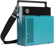 Angled view of the closed blue Victrola record player showing its black carry handle and black shoulder strap.