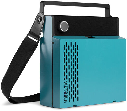 Angled view of the closed blue Victrola record player showing its black carry handle and black shoulder strap.