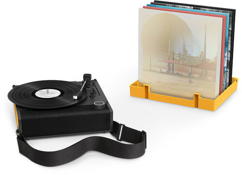 Black Victrola Revolution GO turntable with a shoulder strap beside an orange record holder storing album sleeves.