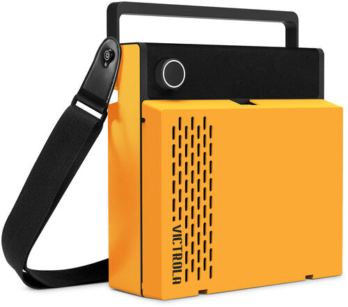 Side view of the orange Victrola Revolution GO case with a black carry handle and shoulder strap, showing the vertical vent grille and 'VICTROLA' text in black on the side.