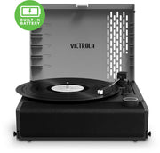 Gray and black portable record player with open gray lid, black platter holding a vinyl record, and the text 'VICTROLA' in black on the inside lid