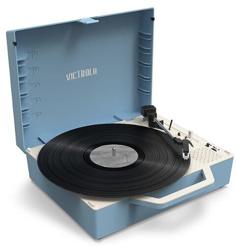 Angled view of an open light blue suitcase turntable with a black vinyl record, cream base, and the text 'VICTROLA' in cream on the lid.