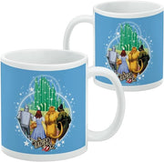 Two blue mugs side by side, one front-facing and one turned to show the same Emerald City design from the side with a small copyright line.