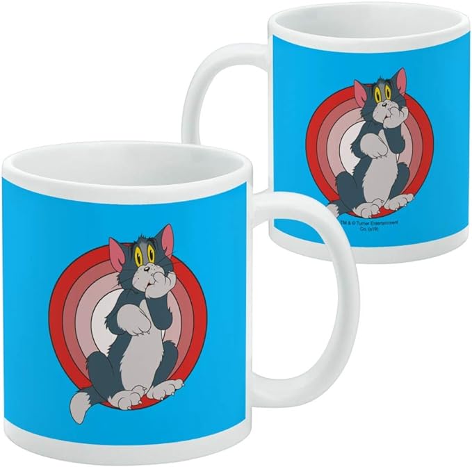 Two blue Tom mugs side by side, one front view and one side view, showing the Tom design and a small copyright line near the base of the side view.