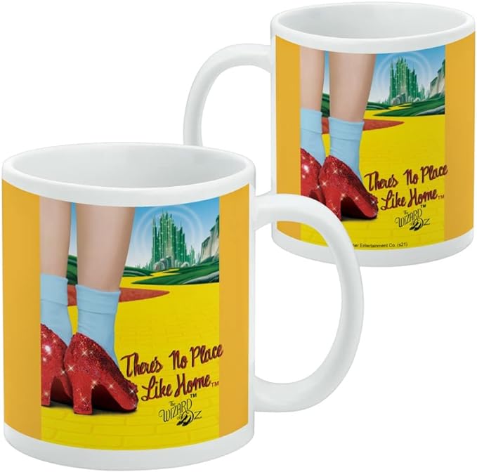 Two Wizard of Oz mugs side by side showing the back of the wrap-around print with the Emerald City and yellow brick road.