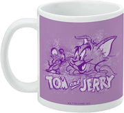 Left side of the lavender-purple Tom and Jerry mug showing Jerry at the left and Tom at the right with the text 'Tom and Jerry' below them.