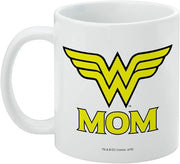 Wonder Woman Mom mug turned with the handle on the left, showing the yellow wing emblem above 'MOM' and a small DC Comics copyright line below.