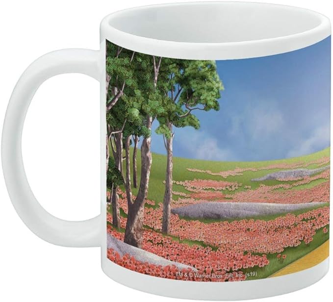 Left side of the white mug showing a tree-lined hill, red poppy field, and blue sky, with a small Warner Bros. copyright line at the bottom.