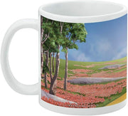 Left side of the Wizard of Oz Dorothy mug showing a grove of trees and a pink poppy field rolling toward the Yellow Brick Road.