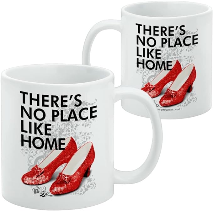 Side-by-side view of white mug showing the red ruby slippers design with a copyright line below the logo.