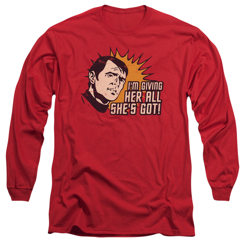 Red long-sleeve shirt featuring a retro comic man against an orange sunburst with the text 'I'M GIVING HER ALL SHE'S GOT!' in cream.