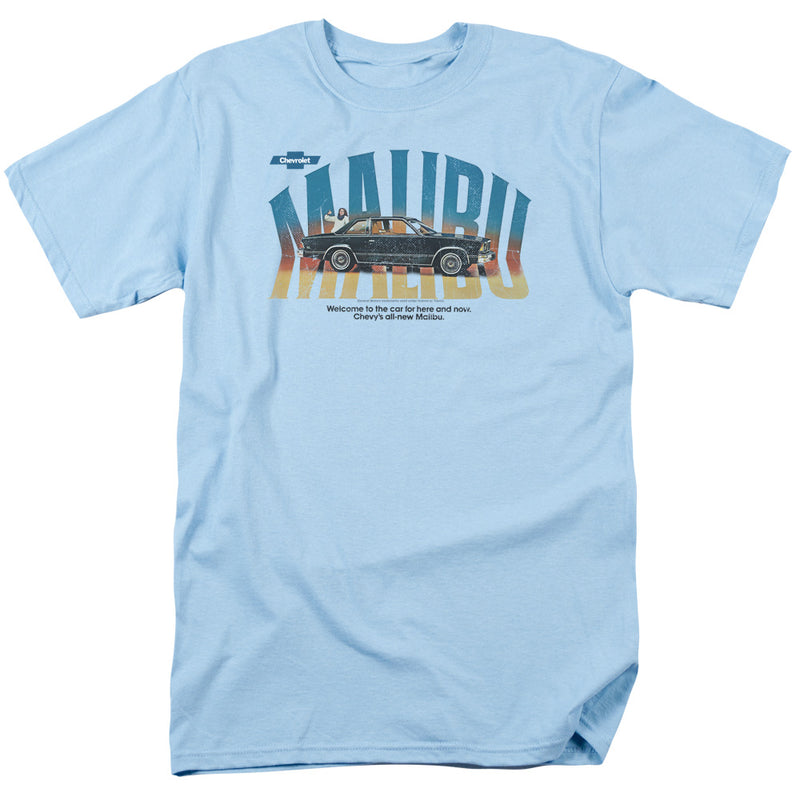 Light blue short-sleeved t-shirt featuring a black Chevrolet Malibu car with the text 'MALIBU' in teal and yellow over a sunset gradient.