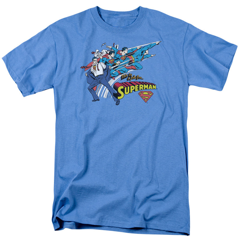 Carolina blue t-shirt featuring a comic panel of Superman changing from Clark Kent's suit with the text 'SUPERMAN' in yellow above a red shield.