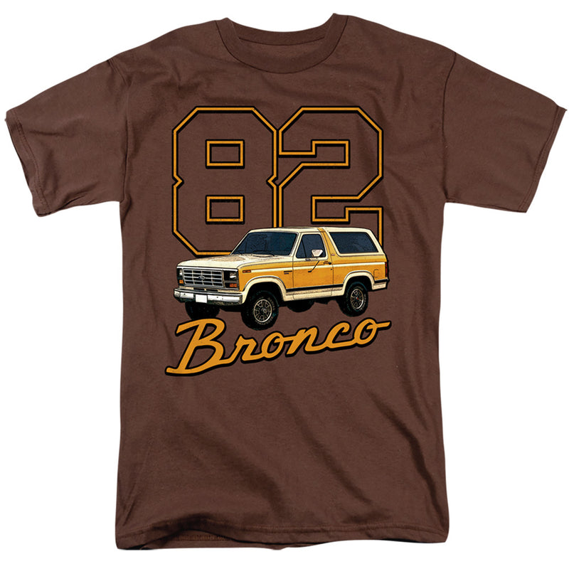 Brown short-sleeved t-shirt featuring a tan and cream Ford Bronco SUV with the number '82' and the text 'Bronco' in orange below it.