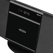 Close-up of the Jensen music system's top control panel, showing the digital clock, Bluetooth label, and CD door with the Jensen logo.