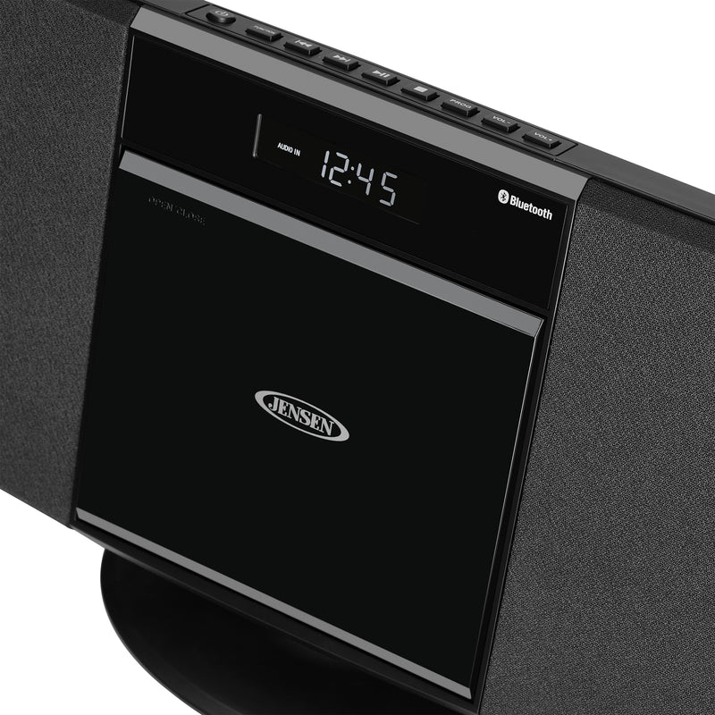 Close-up of the Jensen music system's top control panel, showing the digital clock, Bluetooth label, and CD door with the Jensen logo.
