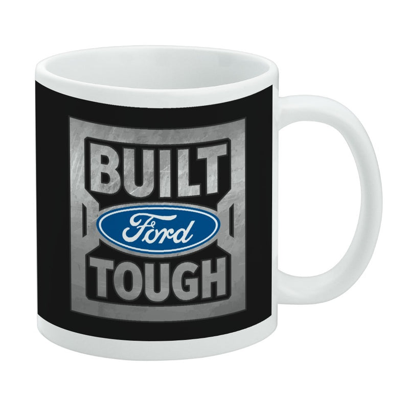 White mug with a black wrap featuring a metallic Built Ford Tough logo with the text 'BUILT' above and 'TOUGH' below a blue Ford oval logo.