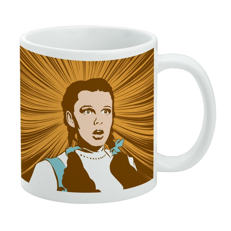White mug featuring a stylized Dorothy from The Wizard of Oz with wide eyes and an open mouth against orange radiating rays