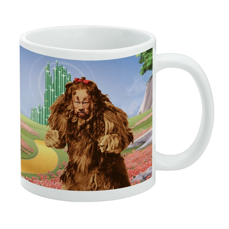 White ceramic mug featuring the Cowardly Lion from The Wizard of Oz walking through a red poppy field toward the Emerald City.