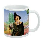 White ceramic mug featuring a full-wrap image of the Scarecrow from The Wizard of Oz in a poppy field before the Emerald City.