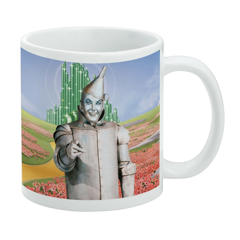 White mug featuring the Tin Man from The Wizard of Oz standing in a red poppy field with the Emerald City behind him.