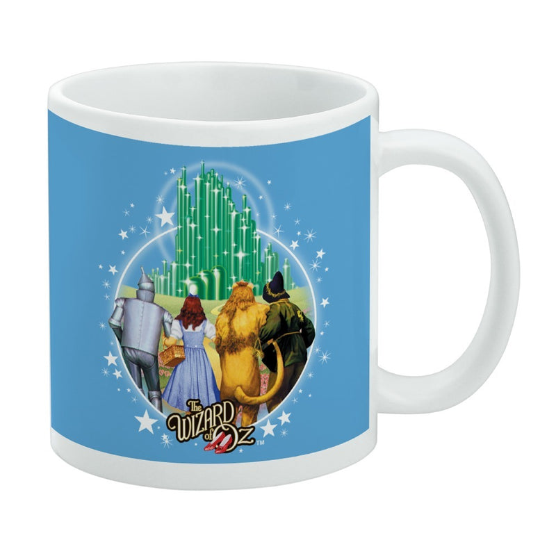 Blue mug featuring Dorothy and friends walking toward the green Emerald City with the text 'The Wizard of Oz' in gold at the lower left.