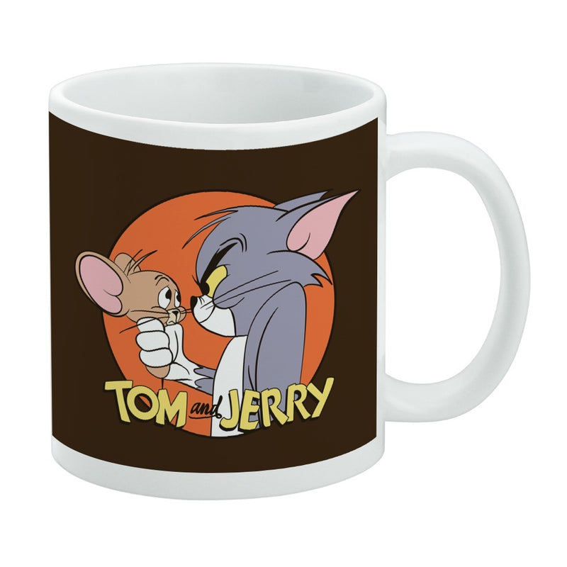 White ceramic mug featuring Tom and Jerry in an orange circle on a brown background with the text 'TOM and JERRY' in yellow below them.