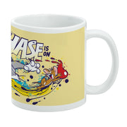 Angled view of a white and yellow mug featuring Tom chasing Jerry with the text 'The Chase is On' in navy blue.
