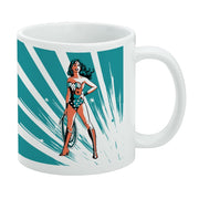 White mug featuring a retro-style illustration of Wonder Woman with her lasso at her side, set against a teal and white starburst background.
