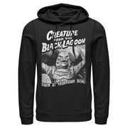 Black hoodie featuring the Creature from the Black Lagoon in a black-and-white photo with the text 'Swim at your own risk!' in white below.