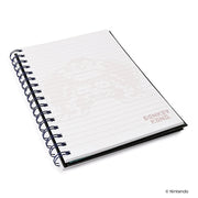 Angled view of open lined pages with faint Donkey Kong pixel artwork and a small 'DONKEY KONG' logo in the lower right.