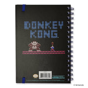 Back cover of the notebook featuring the text 'DONKEY KONG' in blue pixel letters above pixel art of Donkey Kong and Mario on a girder.