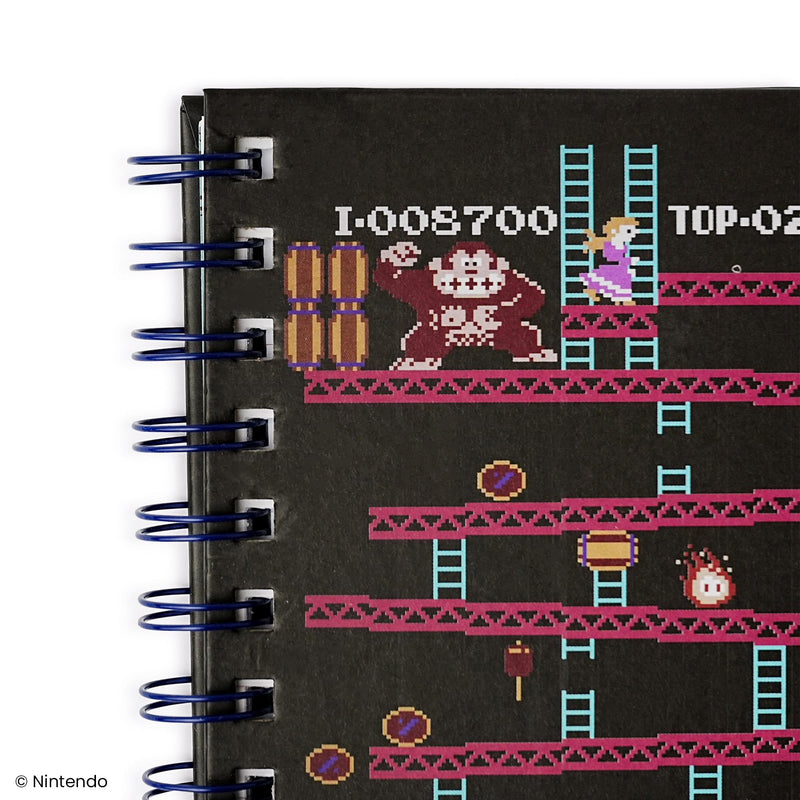 Close-up of the top left of the cover showing Donkey Kong beside stacked barrels and Pauline on a red girder.