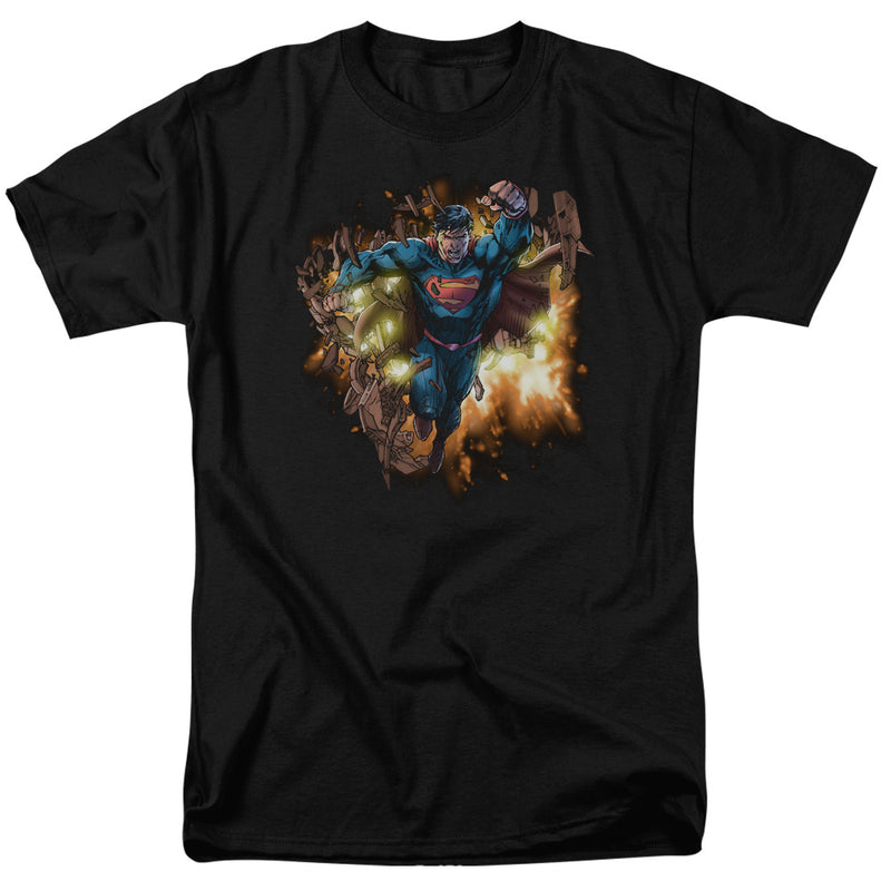 Black short-sleeved t-shirt featuring Superman blasting through a brick wall, with flying debris and orange energy glowing around him.