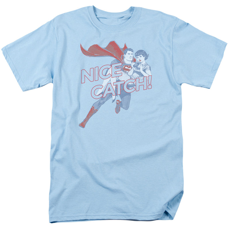 Light blue short-sleeved t-shirt featuring Superman carrying Lois Lane with the text 'NICE CATCH!' in red outlined letters beside them.