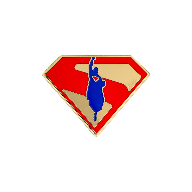 Gold-rimmed enamel pin featuring a red Superman shield with a blue silhouette of Superman flying upward over tan stripes.