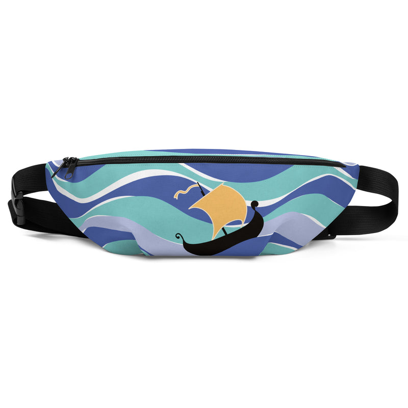 Front view of multicolor fanny pack with wavy stripes of blue and a gold sail on a black ship, with a black zipper and black adjustable strap.