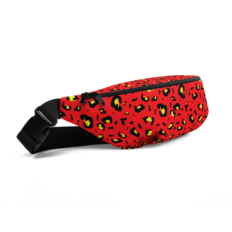 Angled view of red fanny pack with black and yellow cheetah spot print, black zipper along top, and black adjustable buckle strap.