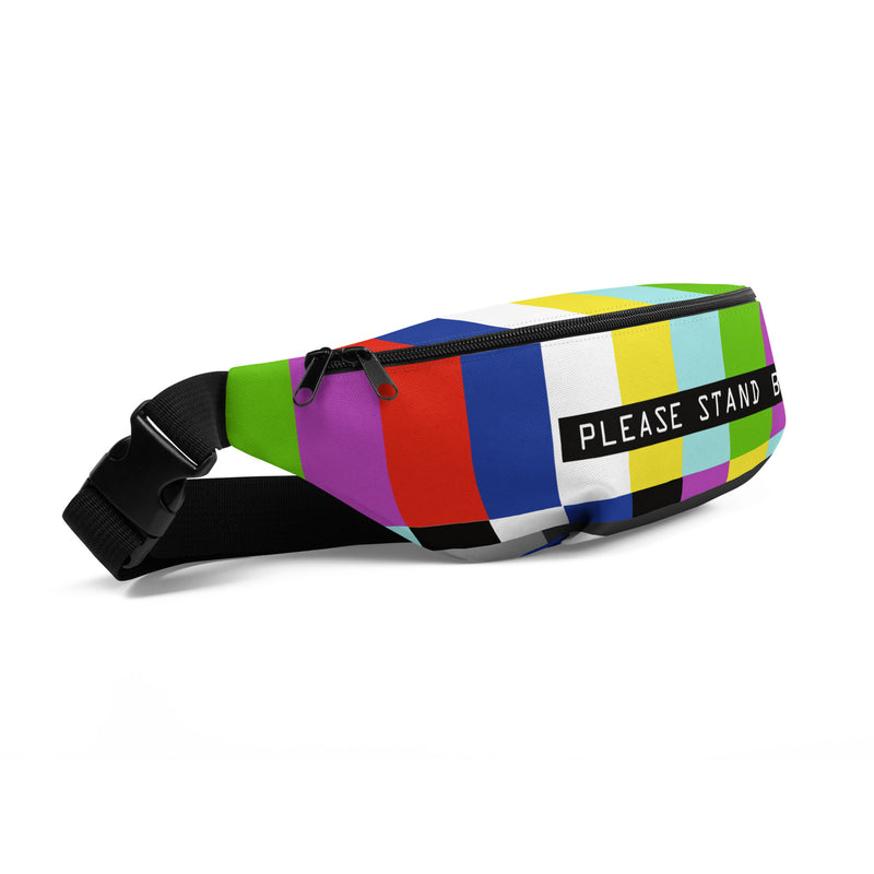 Side view of a fanny pack with a TV test pattern of color bars featuring a black label with text 'PLEASE STAND BY' in white centered on the front.