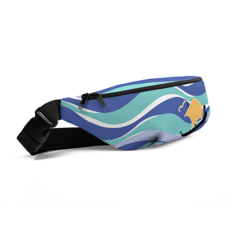 Angled view of multicolor fanny pack with wavy stripes of blue and a gold sail on a black ship, with a black zipper and black adjustable strap.