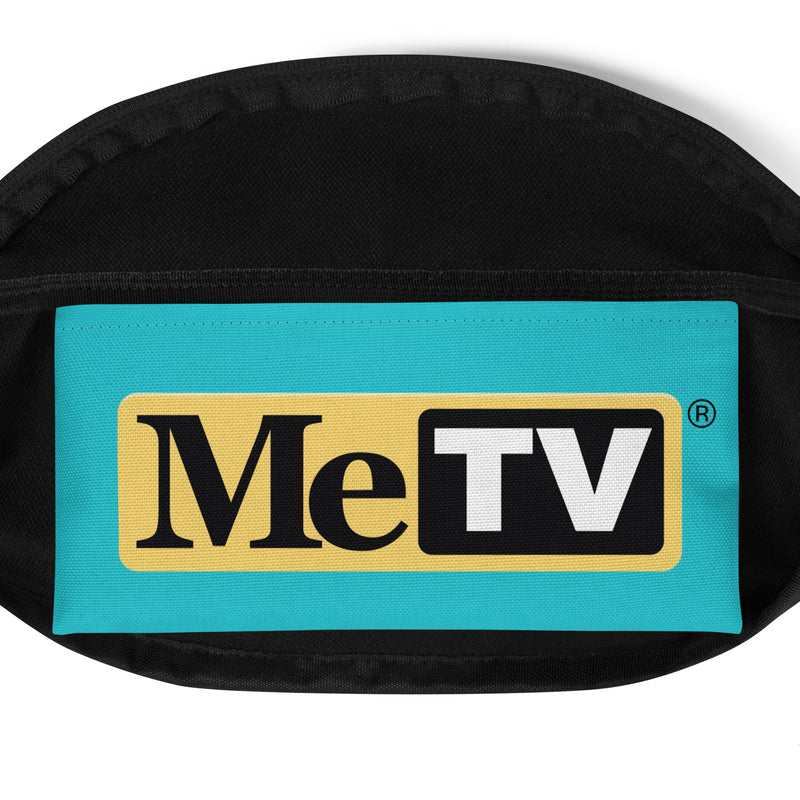 Close-up of black fanny pack with a turquoise front panel featuring the MeTV logo with the text 'MeTV' in black and white on a yellow and black background, with a registered trademark symbol.