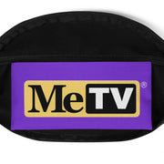 Front view of black fanny pack with a purple panel featuring the MeTV logo with the text 'MeTV' in black and white on a yellow badge with a registered mark.
