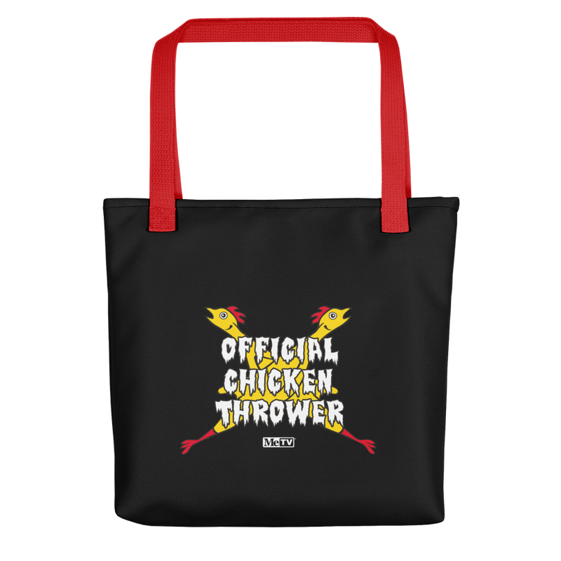 Black tote bag with red handles featuring crossed yellow chickens with the text 'Official Chicken Thrower' in white across the center and a small MeTV logo below.
