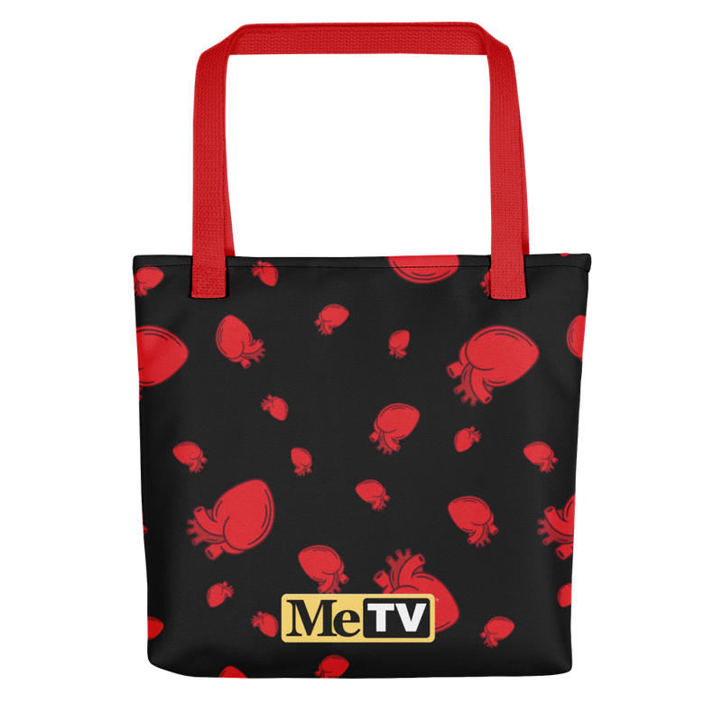 Black tote bag with red handles featuring an all-over pattern of red anatomical hearts and a small yellow MeTV logo near the bottom center.